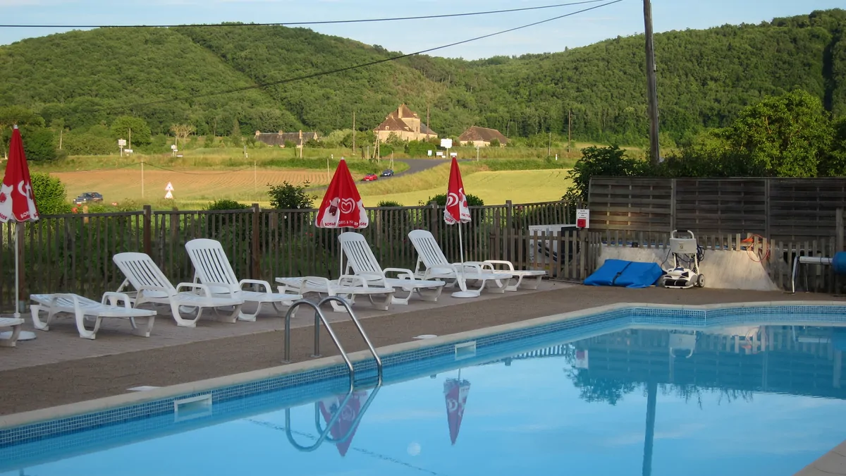 Le Bosquet Campground, its swimming pool, and the wooded landscapes of the Dordogne Valley.